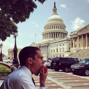 CAPS Fellow Caleb Rollins enjoys an apple for lunch near the Capitol, across the street from LSA's offices.
