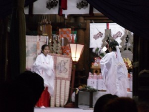 The miko during the Kagura dance.  (I apologize for the poor quality of the photo.  Nighttime is not a good time for photography and most of Japan's streets are not lit well, if at all.)