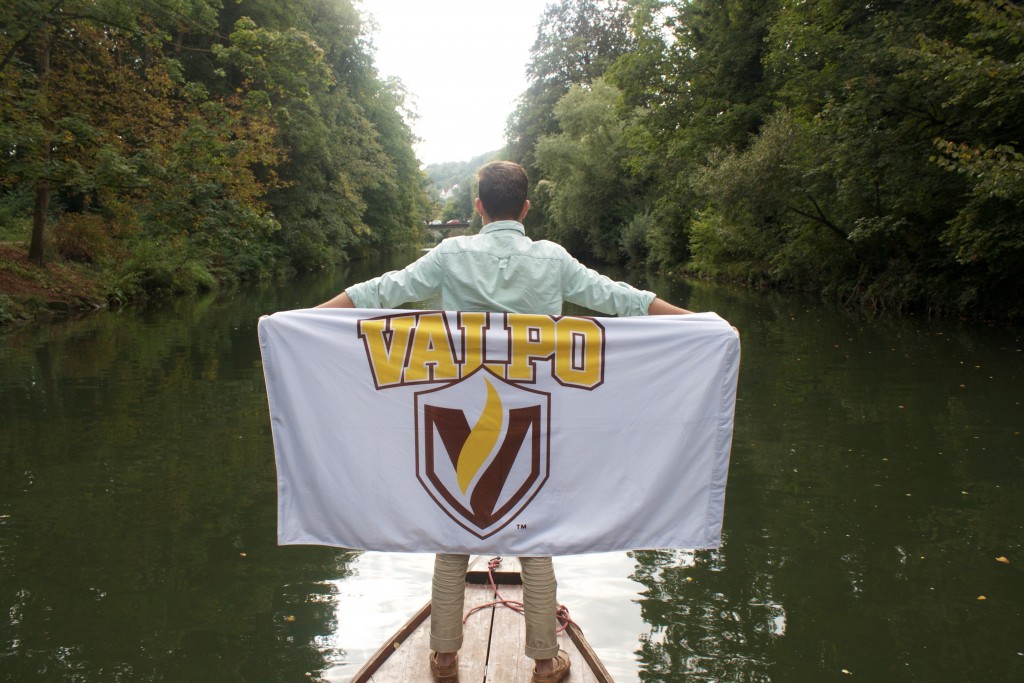 Reid posing with the Valpo flag on the end of the punting boat in Tübingen.