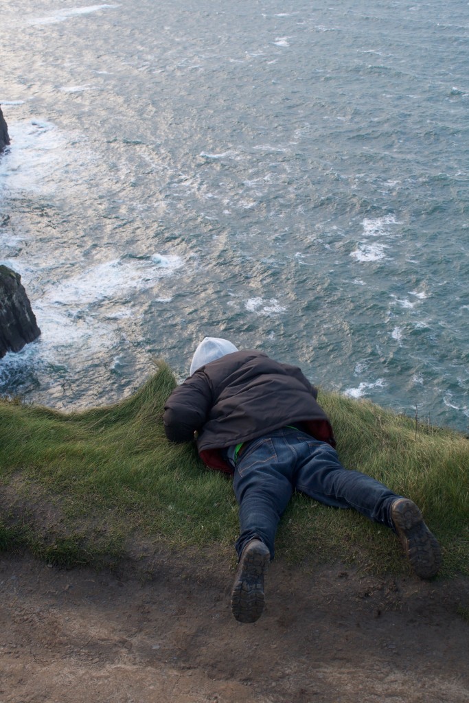 Jon peeking over the edge at the Cliffs of Moher. 