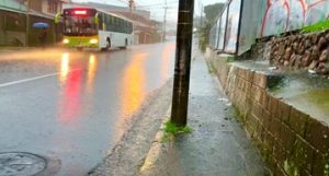 Heavy rain flowing over the road and sidewalks