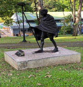 Statue of a man with a walking stick and cloak