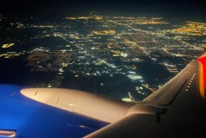 View out of plane window at night of Houston